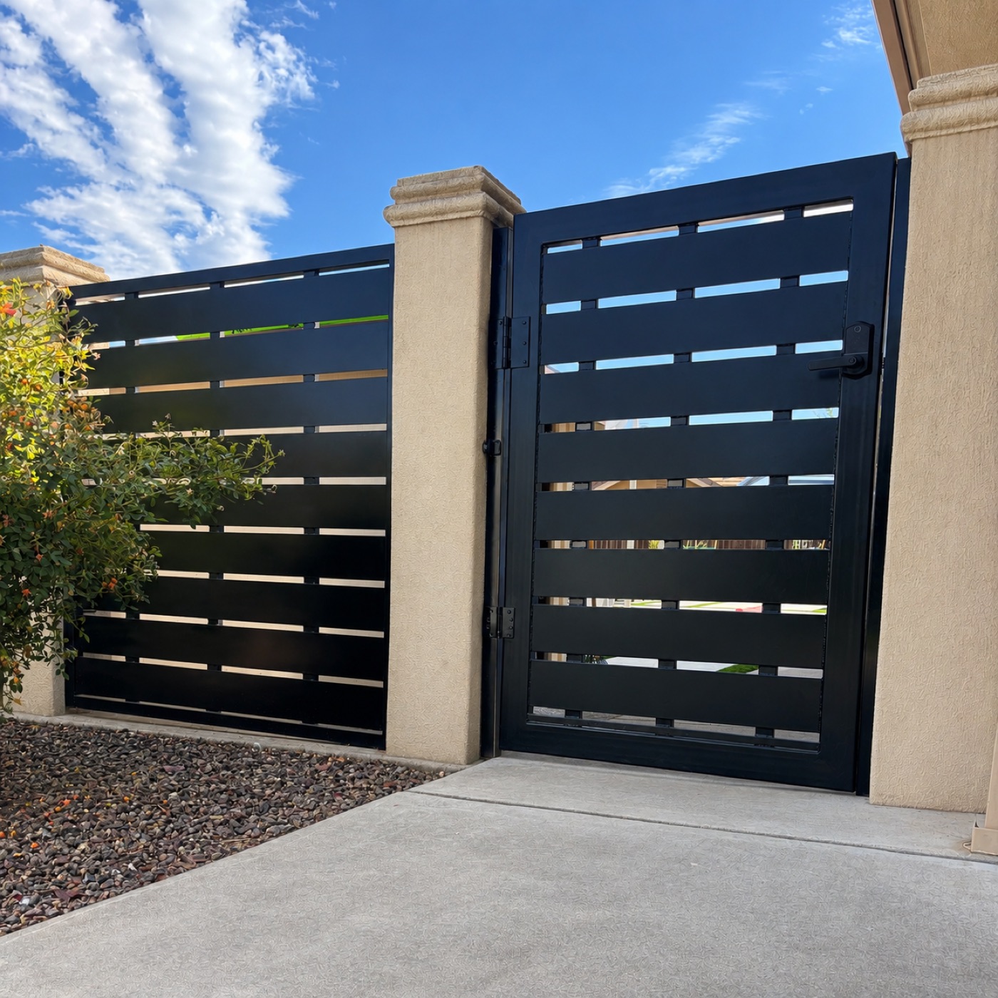 Modern horizontal-slat steel gate and fence at a residential home
